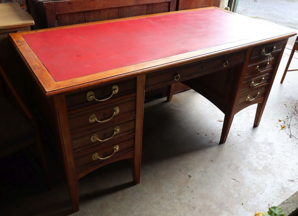 An Edwardian oak and walnut desk, width 160cm depth 74cm height 76cm
